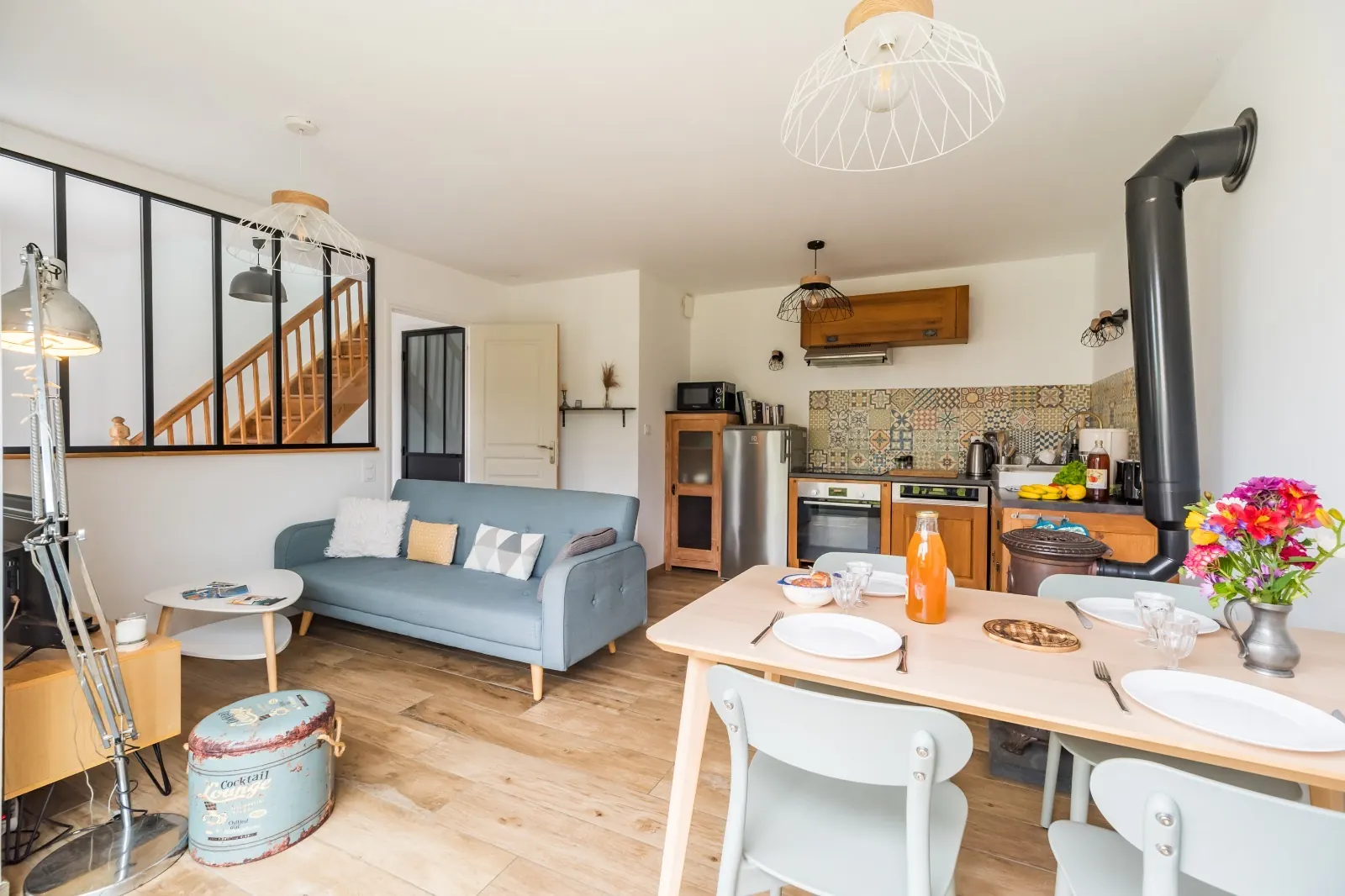 Living area with kitchen and workshop-style glass wall